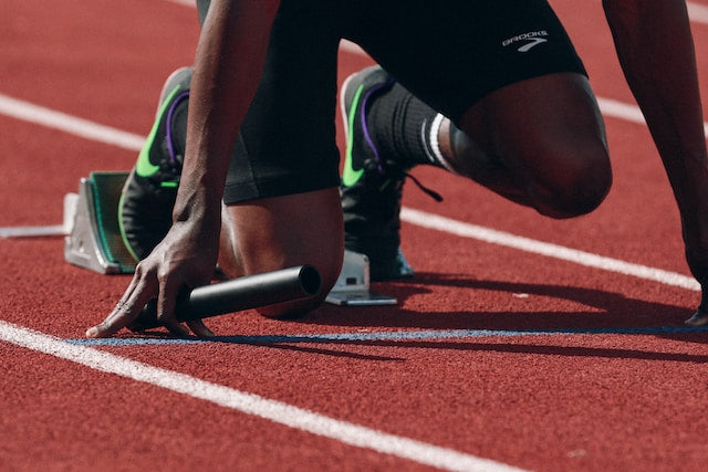 Close-up of moisture-wicking performance fabric stretched across a muscular arm during an intense workout.